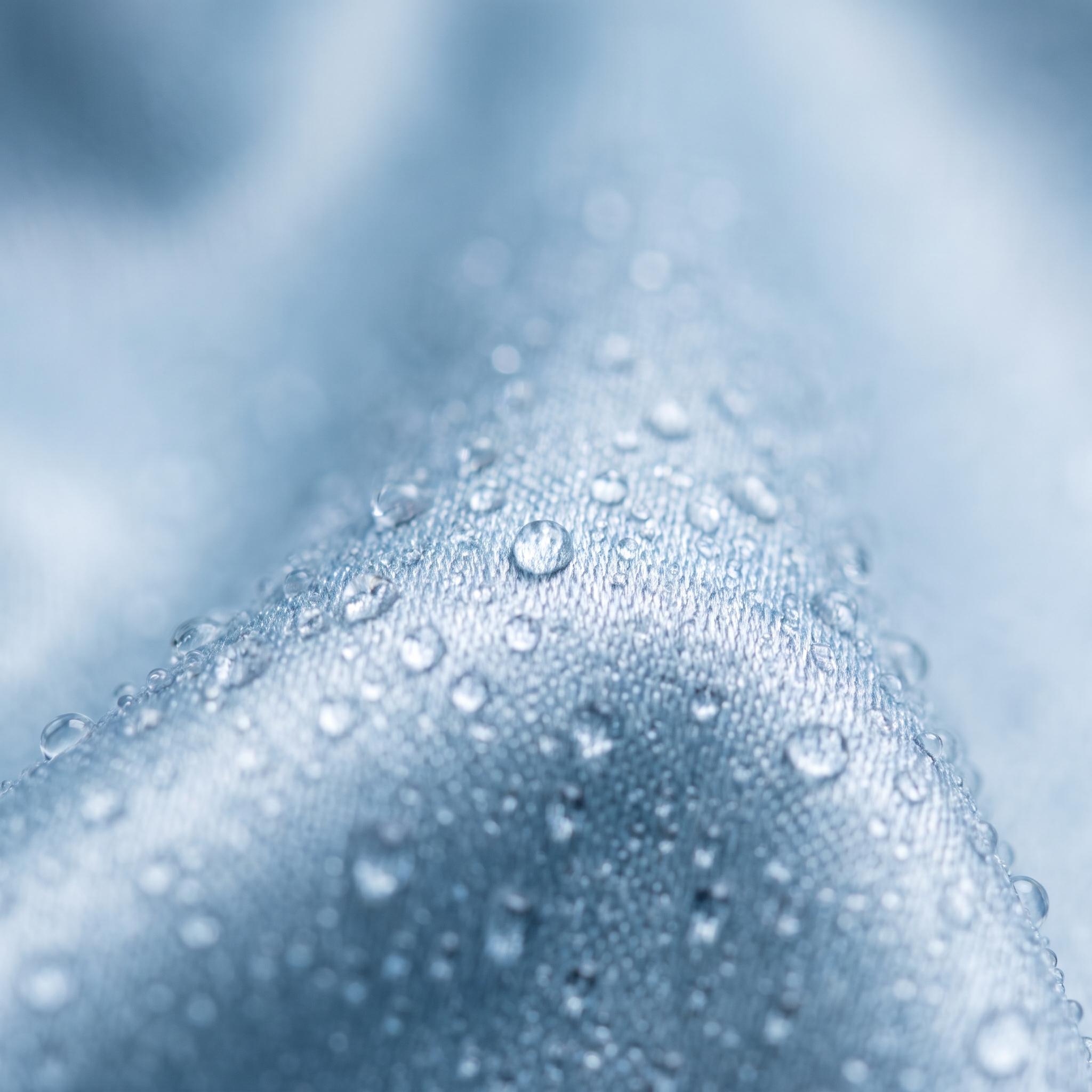 Macro of cool-touch cooling fabric weave with condensation droplets